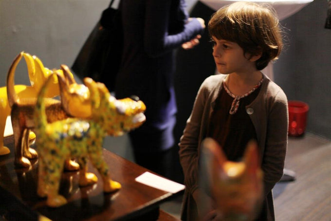 101 Show Child Admiring Yellow Sculpture